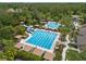 Community pool featuring a lap pool, waterslides, and lounging areas with umbrellas at 27717 Kirkwood Cir, Wesley Chapel, FL 33544