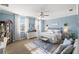 Spacious main bedroom featuring a sitting area, plush carpet, and bright natural light at 27717 Kirkwood Cir, Wesley Chapel, FL 33544