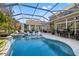 Enjoy the oversized pool with spa, in-pool seating, and adjacent covered seating and dining areas at 27717 Kirkwood Cir, Wesley Chapel, FL 33544