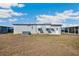 House exterior showing backyard with well-maintained lawn and a view of neighboring homes in the area at 36852 Kimela Ave, Zephyrhills, FL 33542