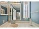Well-lit bathroom with blue walls, white vanity, and a framed mirror offering a functional and fresh aesthetic at 36852 Kimela Ave, Zephyrhills, FL 33542