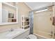 Clean bathroom featuring a vanity with a sink and mirror, along with a shower and storage shelves at 36852 Kimela Ave, Zephyrhills, FL 33542