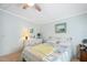 Inviting bedroom features soft lighting, a comfortable bed, and a dresser; offering a tranquil retreat at 36852 Kimela Ave, Zephyrhills, FL 33542