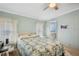 Comfortable bedroom featuring light walls, a bed with a patterned comforter, and an ensuite bathroom at 36852 Kimela Ave, Zephyrhills, FL 33542