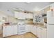 Bright kitchen with white cabinetry, modern appliances, and ample counter space for food preparation at 36852 Kimela Ave, Zephyrhills, FL 33542