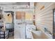 Functional laundry room features a washer, dryer, utility sink, and storage cabinets for convenience at 36852 Kimela Ave, Zephyrhills, FL 33542