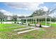 Recreational shuffleboard courts and benches under a canopy, overlooking the serene lake at 36852 Kimela Ave, Zephyrhills, FL 33542