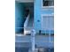 Aqua painted condo building with stairs leading to a second-story unit at 3730 42Nd S Way # K, St Petersburg, FL 33711