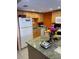 Kitchen with granite countertops, tile flooring, and white appliances at 3730 42Nd S Way # K, St Petersburg, FL 33711