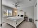 Cozy bedroom with a white bed frame, neutral walls, and ample natural light from the window at 3852 Sorrel Vine Dr, Wesley Chapel, FL 33544