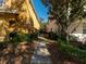 Exterior view between homes with landscaped pathway and green shrubs at 4734 Chatterton Way, Riverview, FL 33578