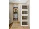 Bathroom entrance featuring modern white storage cabinets and a view into the bathroom at 4777 Duhme Rd # 1A, St Petersburg, FL 33708