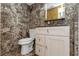 Modern bathroom featuring designer stone-look tile, white vanity, and low-flow toilet at 4777 Duhme Rd # 1A, St Petersburg, FL 33708