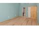 Light and airy bedroom with light hardwood flooring and ensuite bathroom at 4777 Duhme Rd # 1A, St Petersburg, FL 33708
