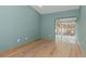 Light blue bedroom featuring hardwood floors and a light archway at 4777 Duhme Rd # 1A, St Petersburg, FL 33708