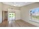 Bright bedroom with hardwood floors, ceiling fan, large windows, and mirrored closet doors at 4777 Duhme Rd # 1A, St Petersburg, FL 33708