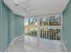 Bright bedroom featuring large windows with views of palm trees and foliage at 4777 Duhme Rd # 1A, St Petersburg, FL 33708