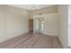 A beige bedroom with a ceiling fan, light hardwood flooring, and a closet with mirrored doors at 4777 Duhme Rd # 1A, St Petersburg, FL 33708