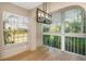 Dining area with a modern light fixture and large windows offering views of tropical foliage at 4777 Duhme Rd # 1A, St Petersburg, FL 33708