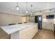 Spacious kitchen featuring a large marble island, stainless steel appliances, and custom cabinets with decorative glass knobs at 4777 Duhme Rd # 1A, St Petersburg, FL 33708