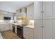 Well-lit kitchen featuring stainless steel appliances, granite countertops, and custom cabinets with decorative glass knobs at 4777 Duhme Rd # 1A, St Petersburg, FL 33708