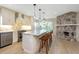 Modern kitchen featuring a marble island, stylish pendant lights, and a stone fireplace nearby at 4777 Duhme Rd # 1A, St Petersburg, FL 33708