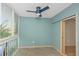 Bright living room featuring a modern ceiling fan and serene teal walls at 4777 Duhme Rd # 1A, St Petersburg, FL 33708