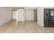Modern living space featuring light wood floors, a barn door accent, and stainless steel refrigerator at 4777 Duhme Rd # 1A, St Petersburg, FL 33708
