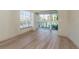 The living room has light hardwood floors and big windows with a view outside at 4777 Duhme Rd # 1A, St Petersburg, FL 33708