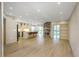 Bright, open-concept living room with a stone fireplace, modern lighting, and hardwood floors at 4777 Duhme Rd # 1A, St Petersburg, FL 33708