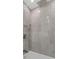 Close up of elegant, tiled shower with rainfall showerhead and handheld sprayer at 4777 Duhme Rd # 1A, St Petersburg, FL 33708