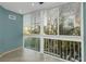 Sun room with large windows, a white railing, and natural light creating a relaxing atmosphere at 4777 Duhme Rd # 1A, St Petersburg, FL 33708