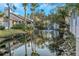 Water view showing a tranquil pond with a fountain surrounded by lush landscaping and charming homes at 4777 Duhme Rd # 1A, St Petersburg, FL 33708