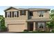 Two-story house with tan siding, brown shutters, and a two-car garage at 4978 Eagle Rock Dr, Wimauma, FL 33598