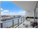 A spacious balcony overlooking a waterfront community, with lounge chairs and potted flowers at 5120 Marina Way # 6603, Tampa, FL 33611