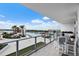 Private balcony with outdoor seating overlooking a pool and waterfront views at 5120 Marina Way # 6603, Tampa, FL 33611