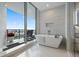 Modern bathroom with a soaking tub in front of a large window with views at 5120 Marina Way # 6603, Tampa, FL 33611