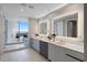 Primary bathroom with double sink vanity, a large mirror, and glass shower with a view at 5120 Marina Way # 6603, Tampa, FL 33611