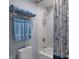 Bathroom with a tub-shower combo with blue patterned shower curtain and towel rack at 5120 Marina Way # 6603, Tampa, FL 33611