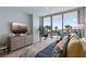 Comfortable bedroom with large window showcasing waterfront view and dresser with decor at 5120 Marina Way # 6603, Tampa, FL 33611