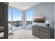 Charming bedroom with a waterfront view and a gray dresser topped with a lamp and decor at 5120 Marina Way # 6603, Tampa, FL 33611