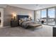 A primary bedroom features a tufted headboard and a beautiful view overlooking the water at 5120 Marina Way # 6603, Tampa, FL 33611
