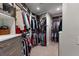 Spacious closet with custom shelves, drawers, hanging racks and carpet floors at 5120 Marina Way # 6603, Tampa, FL 33611