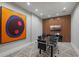 Contemporary conference room with glass table, modern art, and wood accent wall with mounted television at 5120 Marina Way # 6603, Tampa, FL 33611