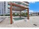 Relaxing rooftop hot tub under a wooden pergola, surrounded by lush greenery and lounge chairs at 5120 Marina Way # 6603, Tampa, FL 33611