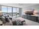 Main bedroom featuring waterfront view, a dresser, and a bench at the foot of the bed at 5120 Marina Way # 6603, Tampa, FL 33611
