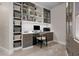 Home office with custom cabinetry, built-in shelving and drawers, carpet floors and modern decor at 5120 Marina Way # 6603, Tampa, FL 33611
