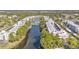 Aerial view of condo community overlooking a serene lake with beautiful surrounding trees at 5980 80Th N St # 410, St Petersburg, FL 33709