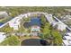 Aerial view of condo community featuring a central pool, lake, and well-maintained landscaping at 5980 80Th N St # 410, St Petersburg, FL 33709