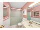 Bathroom with a frosted glass shower door, white tiled floors, and a vanity sink at 5980 80Th N St # 410, St Petersburg, FL 33709